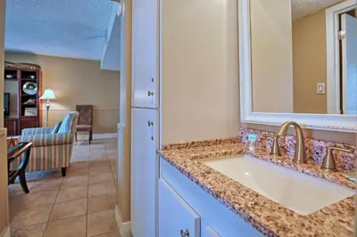 a bathroom with a sink and a mirror at Pinnacle Port B3-307 in Carillon Beach