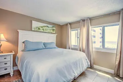 a bedroom with a white bed and a window at Pinnacle Port B3-307 in Carillon Beach
