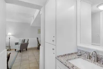 a kitchen with a sink and a living room at Pinnacle Port B3-307 in Carillon Beach