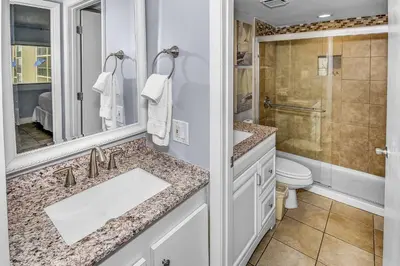a bathroom with a sink and a toilet and a shower at Pinnacle Port B3-307 in Carillon Beach