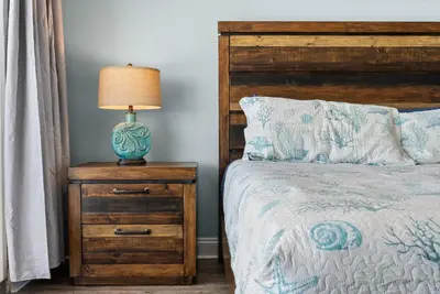 a bedroom with a bed and a lamp on a night stand at Laketown Wharf Remodeled Gulf View Retreat! 3BR Resort Condo with Huge Balcony in Panama City Beach