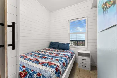 a small bedroom with a bed and a window at Laketown Wharf Remodeled Gulf View Retreat! 3BR Resort Condo with Huge Balcony in Panama City Beach