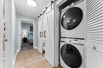 a washing machine and a dryer in a hallway at Laketown Wharf Remodeled Gulf View Retreat! 3BR Resort Condo with Huge Balcony in Panama City Beach