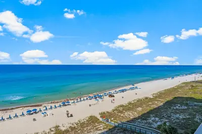 an aerial view of a beach with umbrellas and the ocean at Ocean Reef Beach Resort! Beach Front! Free Seasonal Beach Chairs! by Dolce Vita Getaways PCB in Panama City Beach