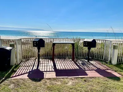 a picnic table on the beach near the ocean at Ocean Reef Beach Resort! Beach Front! Free Seasonal Beach Chairs! by Dolce Vita Getaways PCB in Panama City Beach