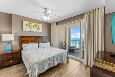 a bedroom with a bed and a view of the ocean at Ocean Reef Beach Resort! Beach Front! Free Seasonal Beach Chairs! by Dolce Vita Getaways PCB in Panama City Beach
