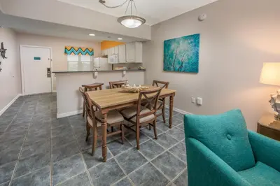 a dining room and kitchen with a table and chairs at Holiday Inn Club Vacations Panama City Beach Resort in Panama City Beach