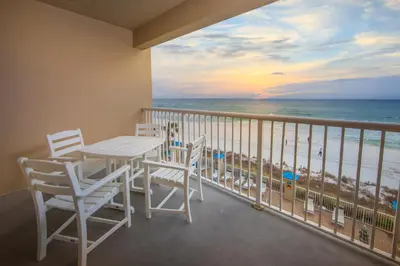 a balcony with a table and chairs and the ocean at Holiday Inn Club Vacations Panama City Beach Resort in Panama City Beach