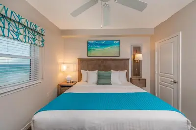 a bedroom with a large bed and a window at Holiday Inn Club Vacations Panama City Beach Resort in Panama City Beach