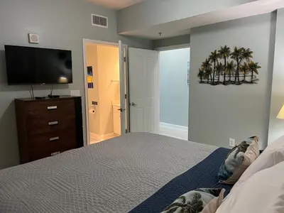a bedroom with a bed and a flat screen tv at Shores of Panama Condo With Same Level Parking in Panama City Beach