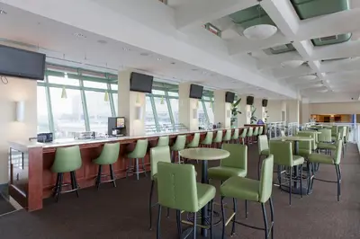 a bar with green chairs and a counter in a room at Emerald Beach in Panama City Beach