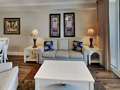 a living room with a couch and two tables at Emerald Beach in Panama City Beach