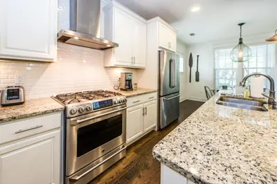 a kitchen with stainless steel appliances and marble counter tops at Anchors Up in Watersound Beach