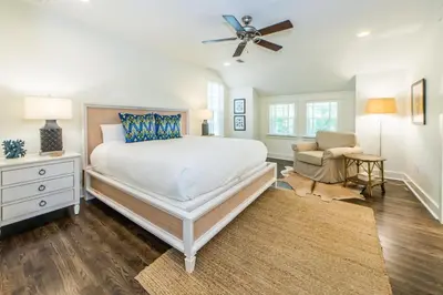 a bedroom with a large bed and a ceiling fan at Anchors Up in Watersound Beach