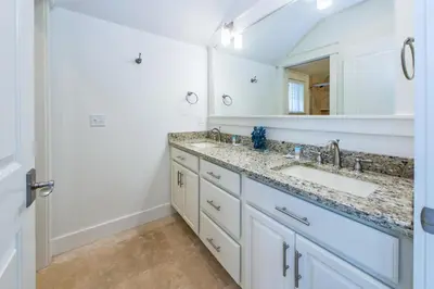 a bathroom with a sink and a mirror at Anchors Up in Watersound Beach
