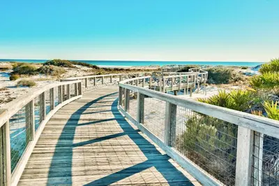 a wooden boardwalk over the sand at the beach at Anchors Up in Watersound Beach