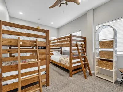 a bedroom with two bunk beds and a ceiling fan at Aweigh From Home in Santa Rosa Beach