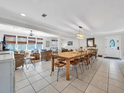 a dining room and kitchen with a table and chairs at Aweigh From Home in Santa Rosa Beach