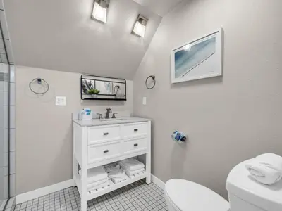 a white bathroom with a sink and a toilet at Aweigh From Home in Santa Rosa Beach
