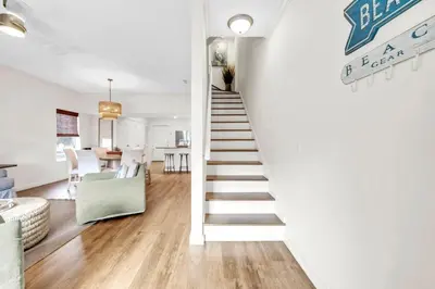 a staircase leading up to a living room and dining room at Palm Grove at Sago Sands Unit A in Seagrove Beach