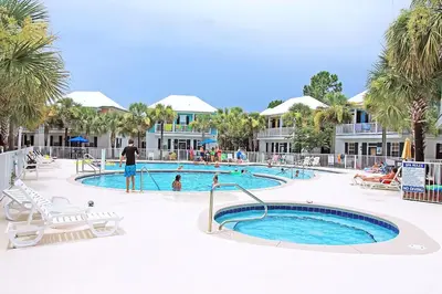 a resort swimming pool with people in the water at Coastal Blue 141 in Seagrove Beach