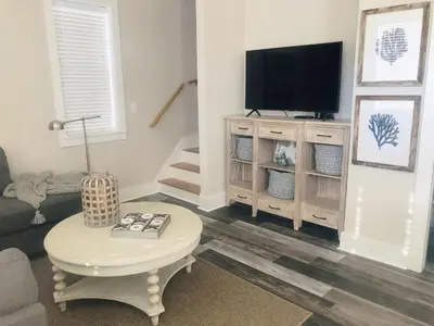 a living room with a tv and a coffee table at Coastal Blue 141 in Seagrove Beach
