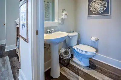 a bathroom with a blue toilet and a sink at Coastal Blue 141 in Seagrove Beach