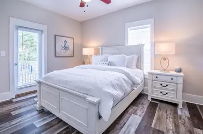a white bedroom with a white bed and a window at Coastal Blue 141 in Seagrove Beach