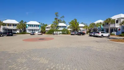 a parking lot with cars parked in front of houses at Coastal Blue 141 in Seagrove Beach