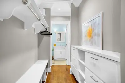 a white hallway with white cabinets and a bathroom at Captain's Cottage in Watersound Beach
