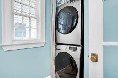 two washing machines in a wall next to a window at Captain's Cottage in Watersound Beach