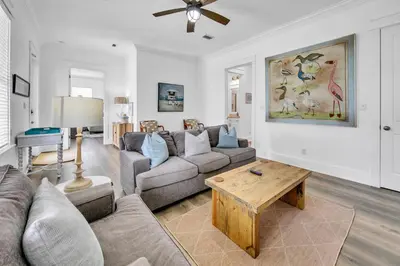 a living room with a couch and a table at Kiwi Grove in Seagrove Beach