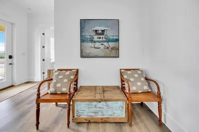 a dining room with two chairs and a table at Kiwi Grove in Seagrove Beach