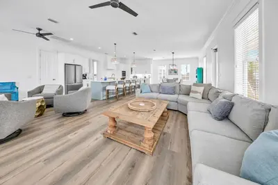 a living room with a couch and a table at Kiwi Grove in Seagrove Beach