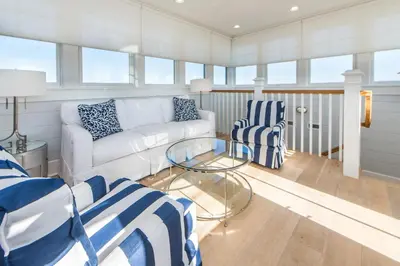 a living room with a couch and a glass table at The Nautilus in Watersound Beach