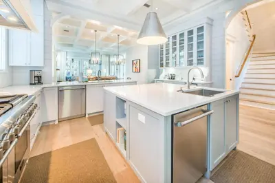 a large white kitchen with a sink and a counter at The Nautilus in Watersound Beach