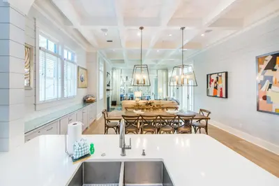 a kitchen with a sink and a dining room at The Nautilus in Watersound Beach