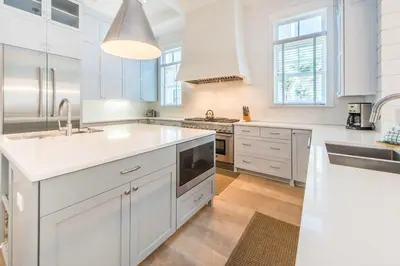 a white kitchen with white cabinets and a sink at The Nautilus in Watersound Beach