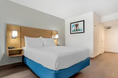 a bed in a hotel room with a large bed at Chateau Beachfront Hotel, a By the Sea Resort in Panama City Beach