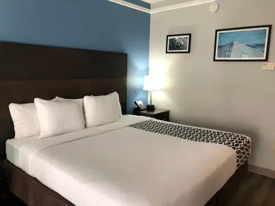 a bedroom with a large bed in a hotel room at La Quinta by Wyndham PCB Coastal Palms in Panama City Beach
