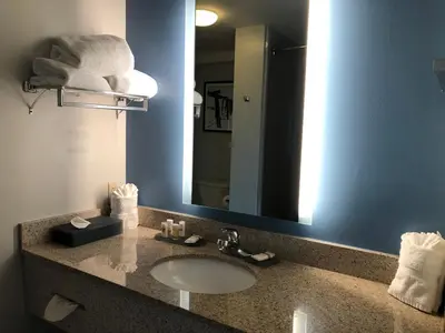 a bathroom with a sink and a mirror at La Quinta by Wyndham PCB Coastal Palms in Panama City Beach