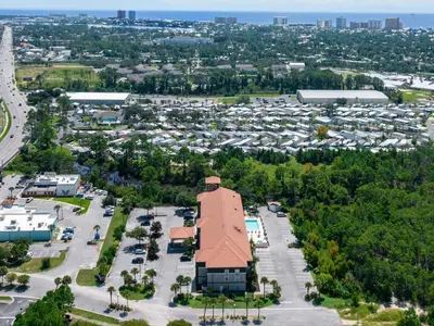 an aerial view of a parking lot with a building at La Quinta by Wyndham PCB Coastal Palms in Panama City Beach