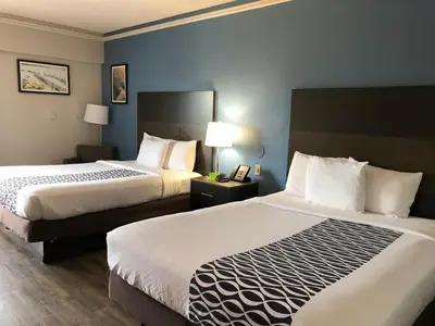 a hotel room with two beds and two lamps at La Quinta by Wyndham PCB Coastal Palms in Panama City Beach