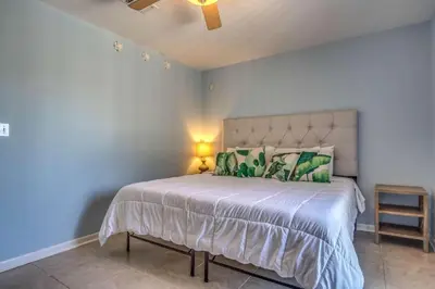 a bedroom with a large bed with a blue wall at Sun and Sand in Inlet Beach