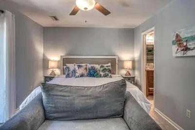 a bedroom with a bed and a ceiling fan at Sun and Sand in Inlet Beach