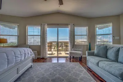a living room with a bed and a couch at Blue Sails in Inlet Beach