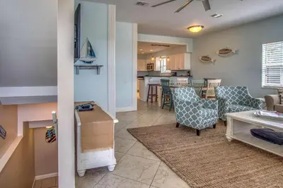 a living room with chairs and a dining room at Blue Sails in Inlet Beach