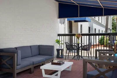 a patio with a couch and a table and chairs at Hampton Inn by Hilton Panama City Beach in Panama City Beach