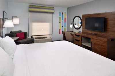 a hotel room with a bed and a desk and a television at Hampton Inn by Hilton Panama City Beach in Panama City Beach