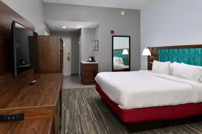 a hotel room with a bed and a television at Hampton Inn by Hilton Panama City Beach in Panama City Beach